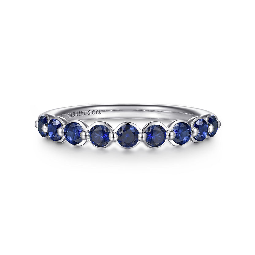The 14K White Gold Sapphire Stackable Ring by Gabriel & Co features deep blue sapphires and an engraved band, adding timeless elegance to any jewelry collection.