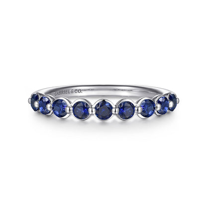 The 14K White Gold Sapphire Stackable Ring by Gabriel & Co features deep blue sapphires and an engraved band, adding timeless elegance to any jewelry collection.