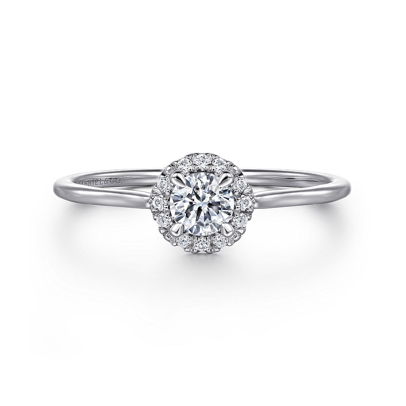 The Gabriel & Co 14K White Gold Promise Ring features a round white sapphire center, surrounded by a sparkling diamond halo on a slim, polished band.