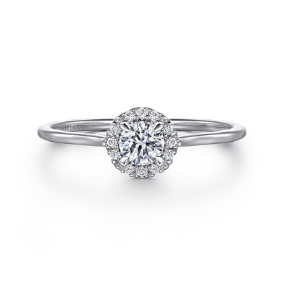 The Gabriel & Co 14K White Gold Promise Ring features a round white sapphire center, surrounded by a sparkling diamond halo on a slim, polished band.