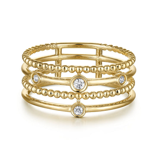 The Gabriel & Co 14K Yellow Gold Bezel Set Diamond Station Layered Ring features four parallel bands—two smooth, two with Bujukan beading—and five evenly spaced, round bezel-set diamonds.