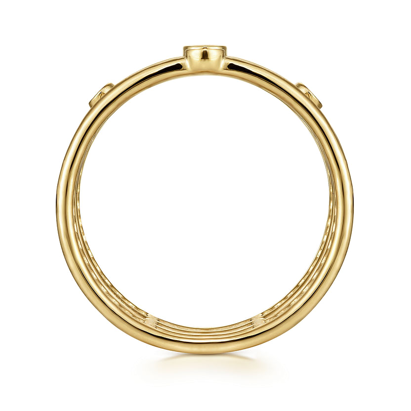 The 14K Yellow Gold Bezel Set Diamond Station Layered Ring by Gabriel & Co features a sleek, polished finish and circular shape, showcased from the side to emphasize its clean lines against a white background.