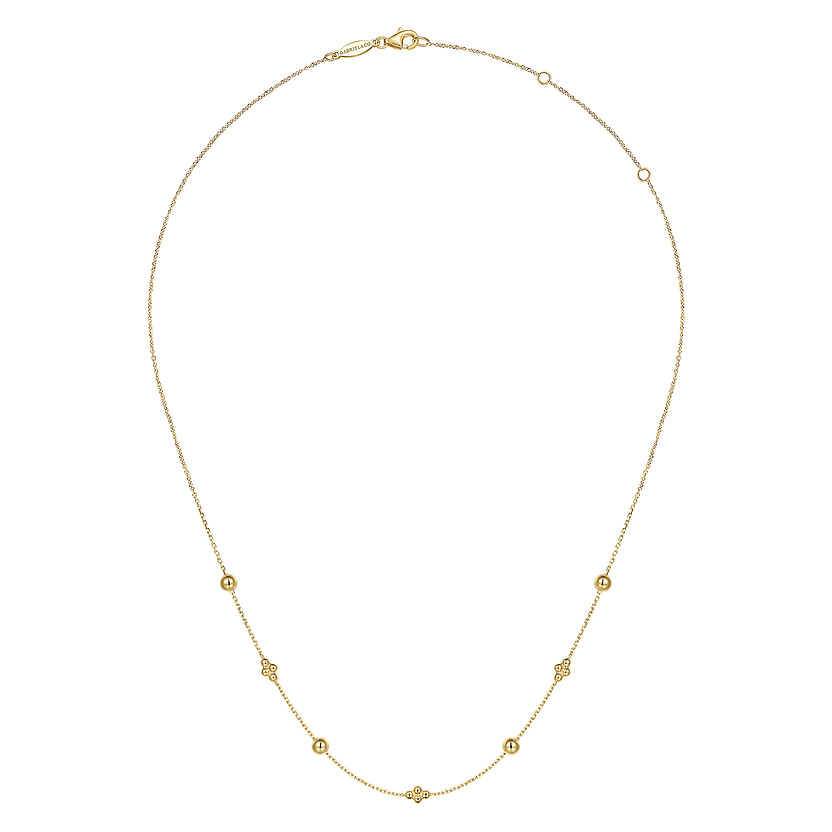The 14K Yellow Gold Bujukan Bead Station Necklace by Gabriel & Co features a fine chain with small, evenly spaced round and floral-inspired beads, secured with a lobster clasp.