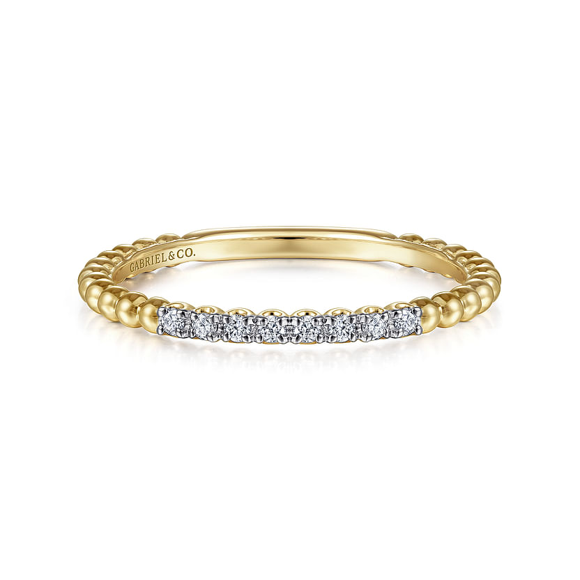 The Gabriel & Co 14K Yellow Gold Bujukan Bead and Diamond Stackable Ring features a beaded band with sparkling diamonds across the top, shown on a white background.