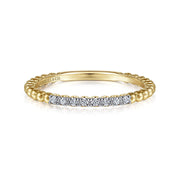The Gabriel & Co 14K Yellow Gold Bujukan Bead and Diamond Stackable Ring features a beaded band with sparkling diamonds across the top, shown on a white background.