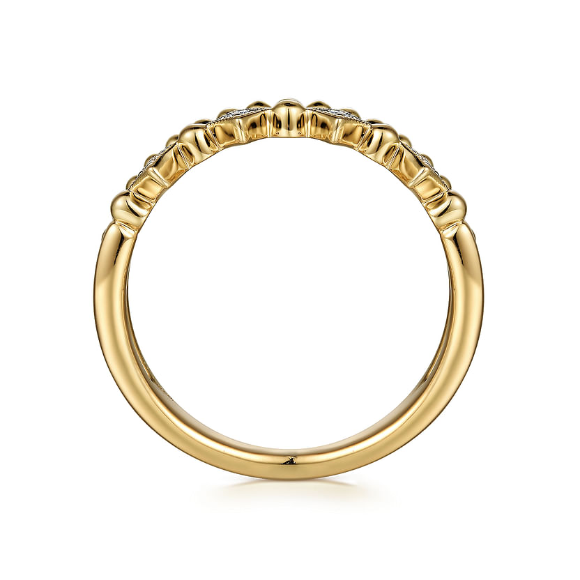 The 14K Yellow Gold Bujukan Diamond Easy Stackable Ring by Gabriel & Co features a side view of round diamonds on the upper half and intricate band detailing, making it an elegant choice for stacking.