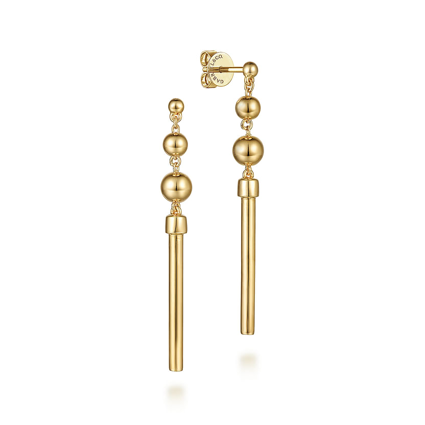 The Gabriel & Co 14K Yellow Gold Bujukan Drop Earrings showcase polished gold spheres and beaded accents stacked above sleek bars for a modern, elegant linear look.