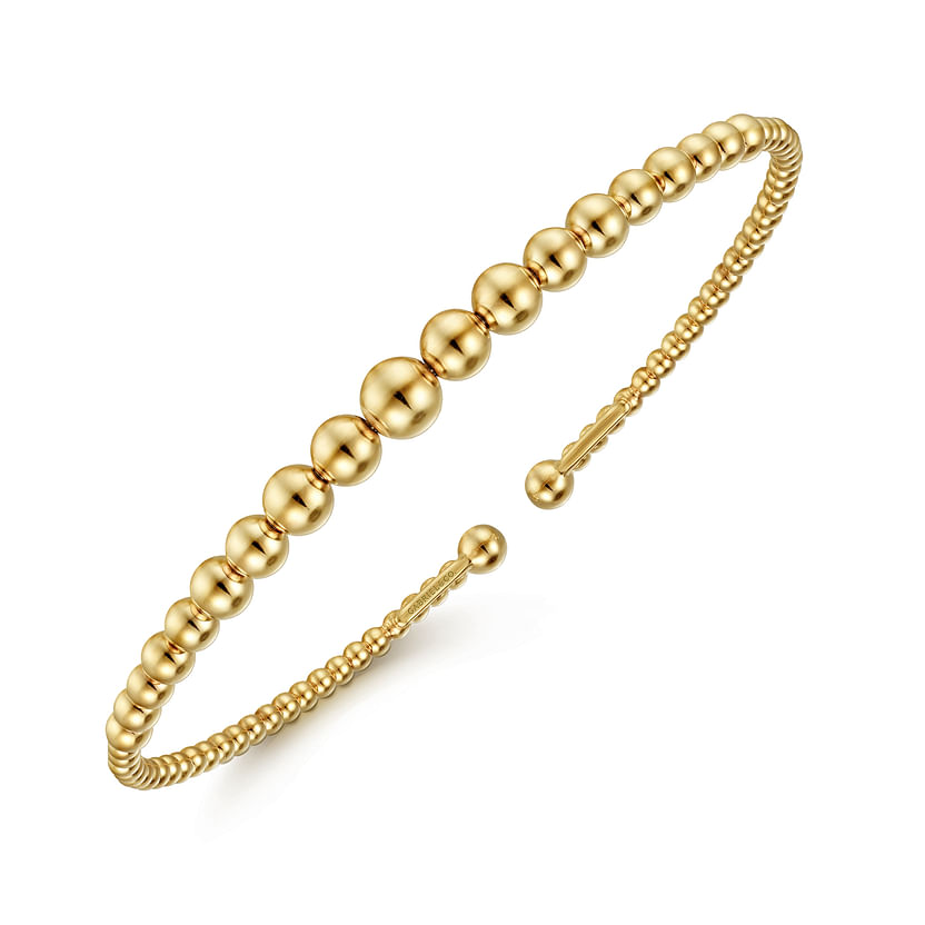 The 14K Yellow Gold Bujukan Open Bangle by Gabriel & Co features polished, graduated beads along its open, adjustable band and is displayed against a plain white background.
