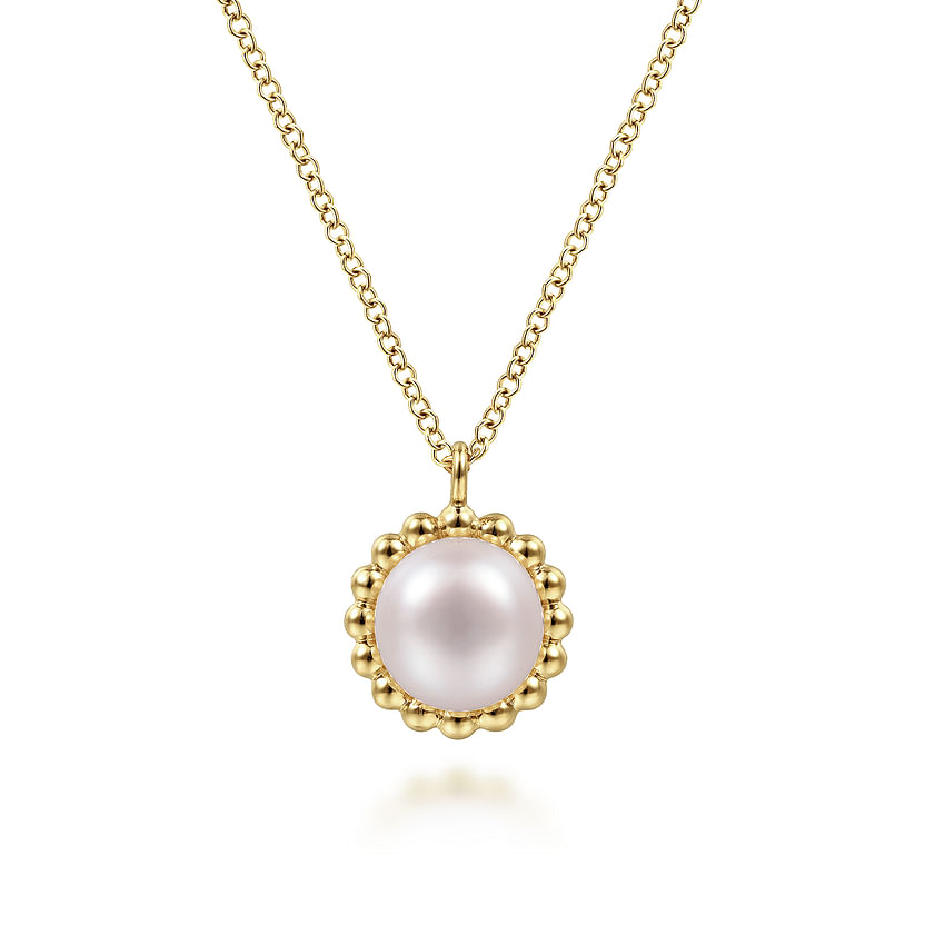 The Gabriel & Co 14K Yellow Gold Bujukan Pearl Pendant Necklace features a round pink pearl framed by a beaded gold border.