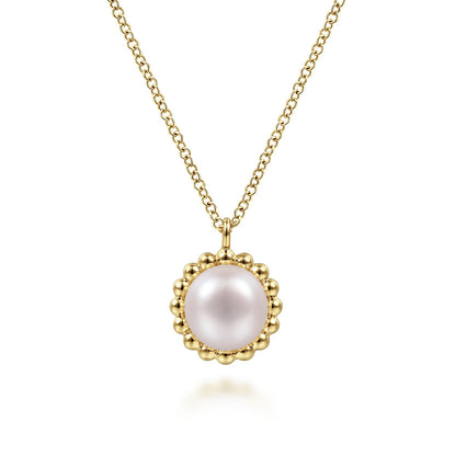 The Gabriel & Co 14K Yellow Gold Bujukan Pearl Pendant Necklace features a round pink pearl framed by a beaded gold border.