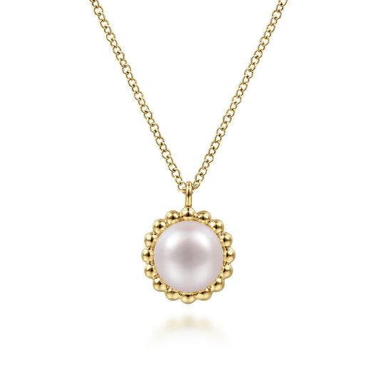 The Gabriel & Co 14K Yellow Gold Bujukan Pearl Pendant Necklace features a round pink pearl framed by a beaded gold border.