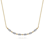 The Gabriel & Co 14K Yellow Gold Curved Bujukan Bar Diamond Necklace features a curved bar with alternating diamond-encrusted, leaf-shaped segments and gold bead accents.