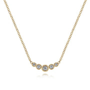 The Gabriel & Co 14K Yellow Gold Curved Diamond Bar Necklace features five bezel-set diamonds in a gentle curve, with a larger center stone for vintage charm on a classic white background.