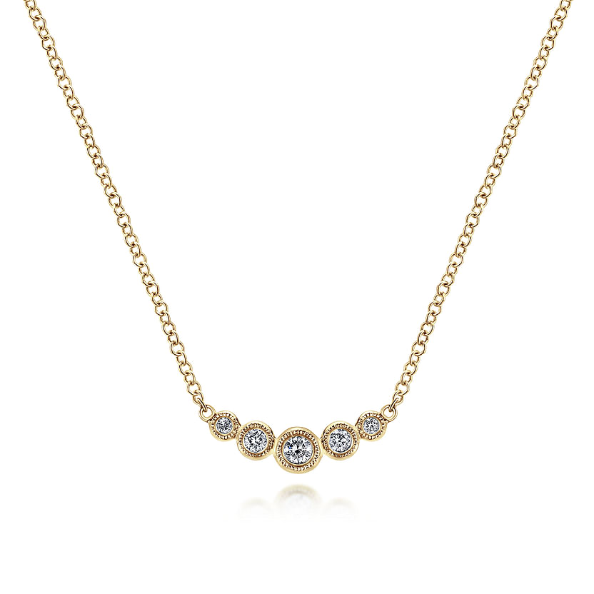 The Gabriel & Co 14K Yellow Gold Curved Diamond Bar Necklace features five bezel-set diamonds in a gentle curve, with a larger center stone for vintage charm on a classic white background.