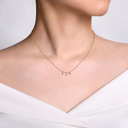 A woman in an off-the-shoulder white top showcases the Gabriel & Co 14K Yellow Gold Diamond Drop Pendant Necklace against a plain light background.