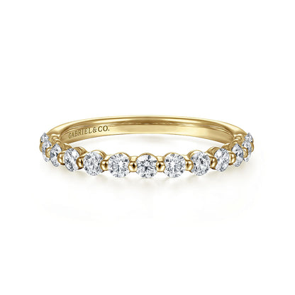 The 14K Yellow Gold Diamond Ladies Ring by Gabriel & Co features a row of natural diamonds on the top half and an engraved inside band, combining stackable luxury with an elegant, delicate design.