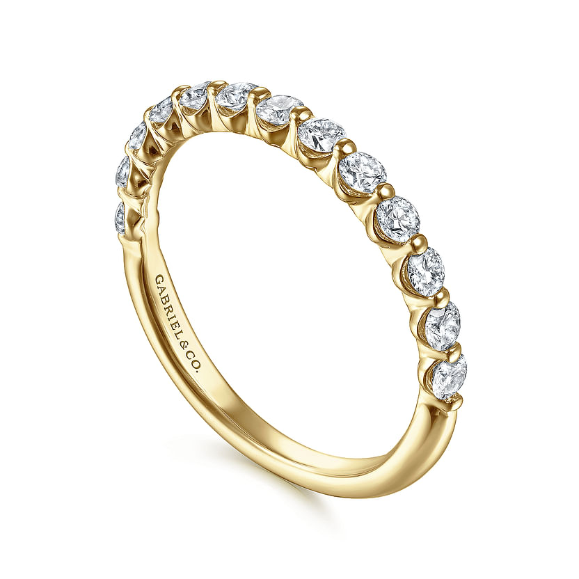 The 14K Yellow Gold Diamond Ladies Ring by Gabriel & Co features a row of natural diamonds set on the top half of the band and is engraved inside with "GABRIEL & CO."—a stackable luxury for any collection.