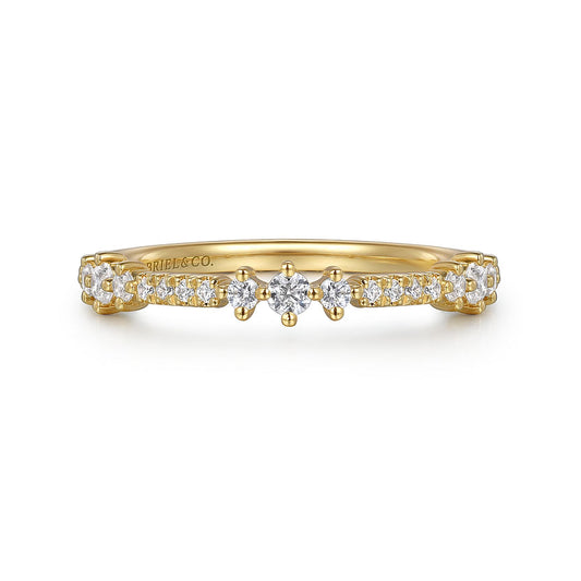 The 14K Yellow Gold Diamond Ladies Ring by Gabriel & Co features a row of small natural diamonds and a central star-like cluster. "GABRIEL & CO." is engraved inside the band. Ideal for stacking.