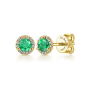The 14K Yellow Gold Diamond and Emerald Halo Stud Earrings by Gabriel & Co feature round emeralds encircled by diamond halos with secure screw-backings, displayed on a white background.
