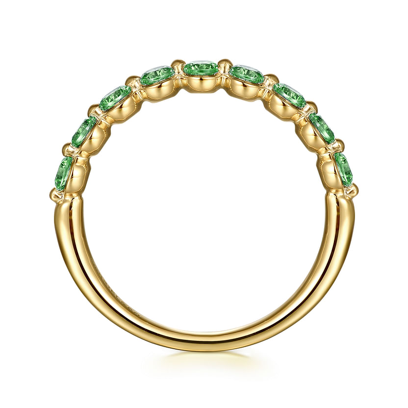 The 14K Yellow Gold Emerald Stackable Ring by Gabriel & Co features a row of oval green emeralds, the May birthstone, set along the top half, shown from the side on a white background.