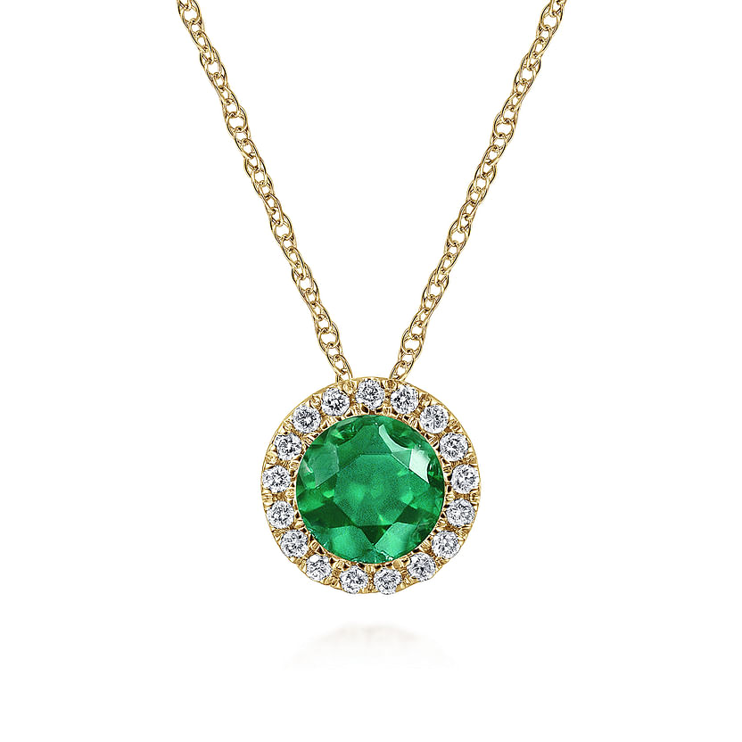 The Gabriel & Co 14K Yellow Gold Emerald and Diamond Halo Pendant Necklace features a round green emerald framed by sparkling diamonds—an elegant May birthstone gift, shown on a plain white background.