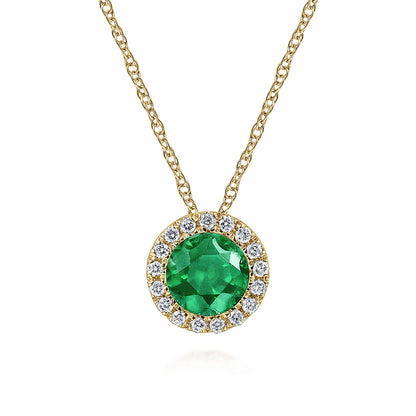 The Gabriel & Co 14K Yellow Gold Emerald and Diamond Halo Pendant Necklace features a round green emerald framed by sparkling diamonds—an elegant May birthstone gift, shown on a plain white background.