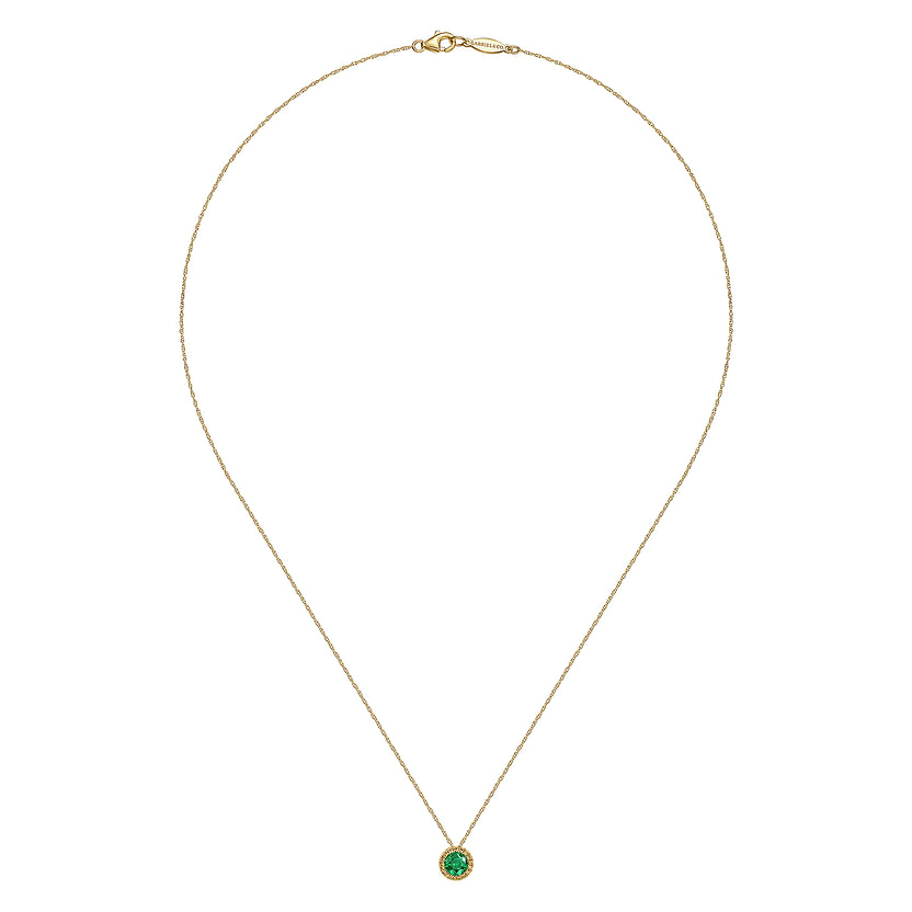 The Gabriel & Co 14K Yellow Gold Emerald and Diamond Halo Pendant Necklace features a vibrant round emerald, perfect as a May birthstone gift, elegantly showcased against a plain white background.