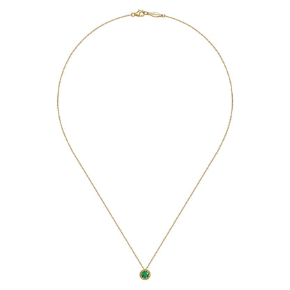 The Gabriel & Co 14K Yellow Gold Emerald and Diamond Halo Pendant Necklace features a vibrant round emerald, perfect as a May birthstone gift, elegantly showcased against a plain white background.