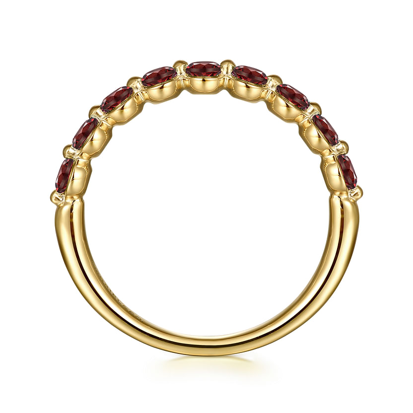 The Gabriel & Co 14K Yellow Gold Garnet Stackable Ring features a row of marquise-cut garnet stones set along the top half, viewed from the side to showcase the gems and the ring's smooth, polished finish.