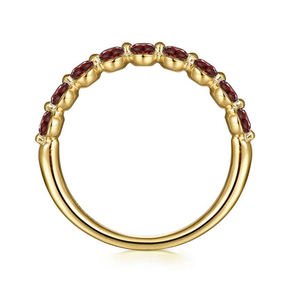 The Gabriel & Co 14K Yellow Gold Garnet Stackable Ring features a row of marquise-cut garnet stones set along the top half, viewed from the side to showcase the gems and the ring's smooth, polished finish.