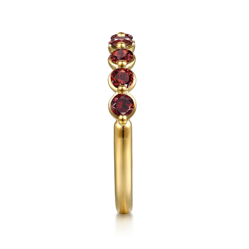 The Gabriel & Co 14K Yellow Gold Garnet Stackable Ring features four round garnet gemstones set vertically, shown from the side against a white background.