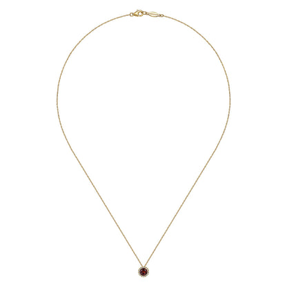 The Gabriel & Co 14K Yellow Gold Garnet and Diamond Halo Pendant Necklace features a delicate gold chain and a round garnet center accented by a sparkling diamond halo.