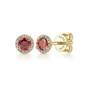 Gabriel & Co 14K Yellow Gold Round Halo Garnet and Diamond Stud Earrings feature round garnet gems encircled by small diamonds in a halo design and have secure screw-back closures.