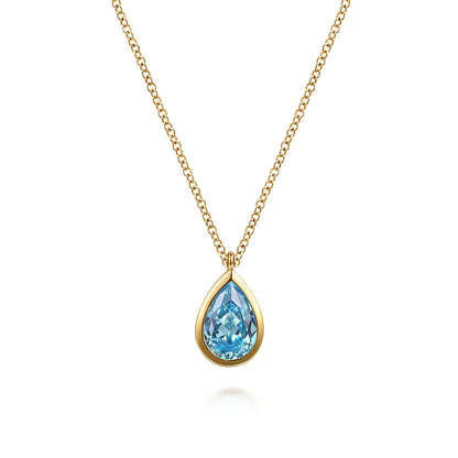 The Gabriel & Co 14K Yellow Gold Teardrop Blue Topaz Pendant Necklace is an elegant December birthstone gift, featuring a stunning blue topaz in a gold setting, beautifully showcased on a white background.