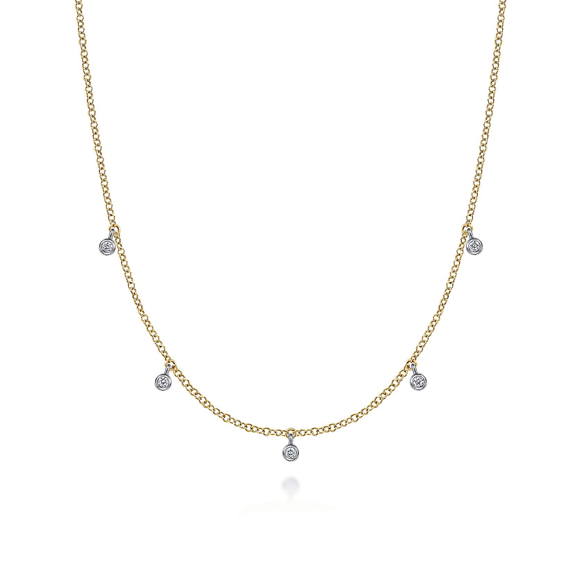 The Gabriel & Co 14K Yellow-White Gold Diamond Stations Droplet Necklace from the Contemporary Collection features five small round diamond pendants spaced along a delicate chain, shown on a white background.