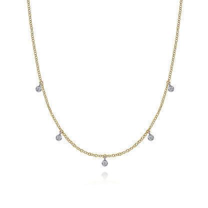 The Gabriel & Co 14K Yellow-White Gold Diamond Stations Droplet Necklace from the Contemporary Collection features five small round diamond pendants spaced along a delicate chain, shown on a white background.