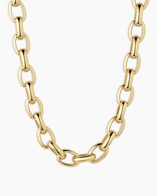 The Gorjana Avery Statement Necklace features thick, oval links and a lustrous 18k gold plated finish. The necklace is displayed in a U-shape against a plain white background, with its clasp and ends hidden from view.