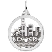 The Rembrandt Charms New York Skyline Charm in sterling silver is expertly crafted in the shape of a circular pendant, depicting the iconic New York skyline with "NEW YORK" inscribed beneath it. This elegant design beautifully captures the cityscape and waves symbolizing water. It includes a top loop for easy attachment to a chain or necklace.