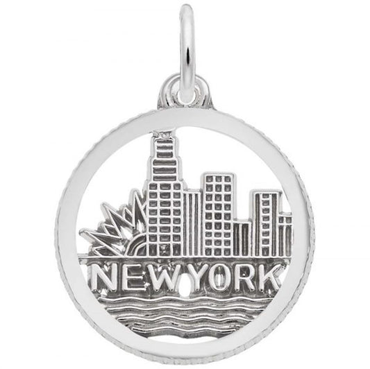 The Rembrandt Charms New York Skyline Charm in sterling silver is expertly crafted in the shape of a circular pendant, depicting the iconic New York skyline with "NEW YORK" inscribed beneath it. This elegant design beautifully captures the cityscape and waves symbolizing water. It includes a top loop for easy attachment to a chain or necklace.