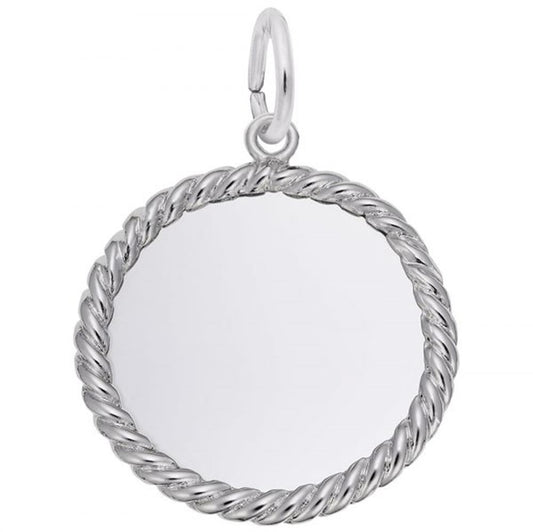 The Rope Disc Charm by Rembrandt Charms is a round, sterling silver pendant featuring a twisted rope design around the edges and a small loop at the top for easy attachment to a chain. The center of this charm is smooth and reflective, resembling a small mirror.