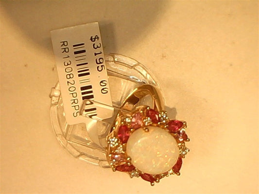 A 14k rose gold Opal, Pink Sapphire, Ruby, and Diamond ring (size 6.75) by Ryan Gems sits on a light background with a price tag of $3195.00 and product code attached. Central opal is accented by rubies and clear stones.