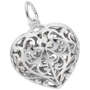 The Rembrandt Charms Filigree Heart Charm in sterling silver showcases an intricate openwork filigree design, adorned with delicate floral and swirling patterns. This exquisite charm also features a small loop at the top, perfect for attaching to a chain or bracelet.