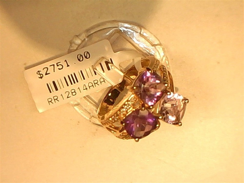 The Ryan Gems Mixed Amethyst bubble ring in 14k rose gold, size 6.75, features two large square-cut amethysts and accent stones. Displayed on a clear stand, it’s priced at $2751.00 (code: RR12814RRA).