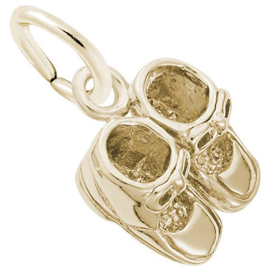 The image shows the Gold Plated Sterling Silver Baby Booties Accent Charm from Rembrandt Charms. The charm is crafted in gold plated sterling silver and features a pair of detailed baby booties. It measures 0.36 inches by 0.42 inches (9.1 mm x 10.59 mm) and has the style number 0516. This charm is a perfect keepsake for commemorating the early days of a new baby.