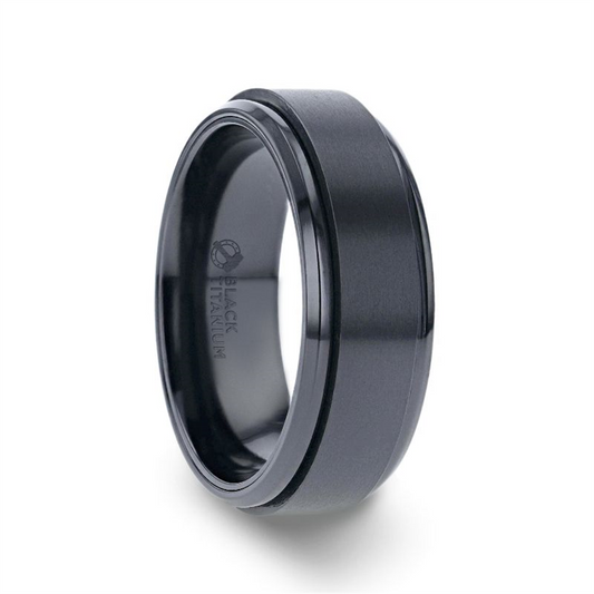 The PHANTOM Black Titanium Spinner Ring by Thorsten is a modern, sleek accessory crafted from black titanium with a brushed finish and beveled edges. The polished interior, subtly engraved with "Black Titanium," exudes sophistication. This 8mm ring adds an extra layer of elegance through its dark, reflective luster.