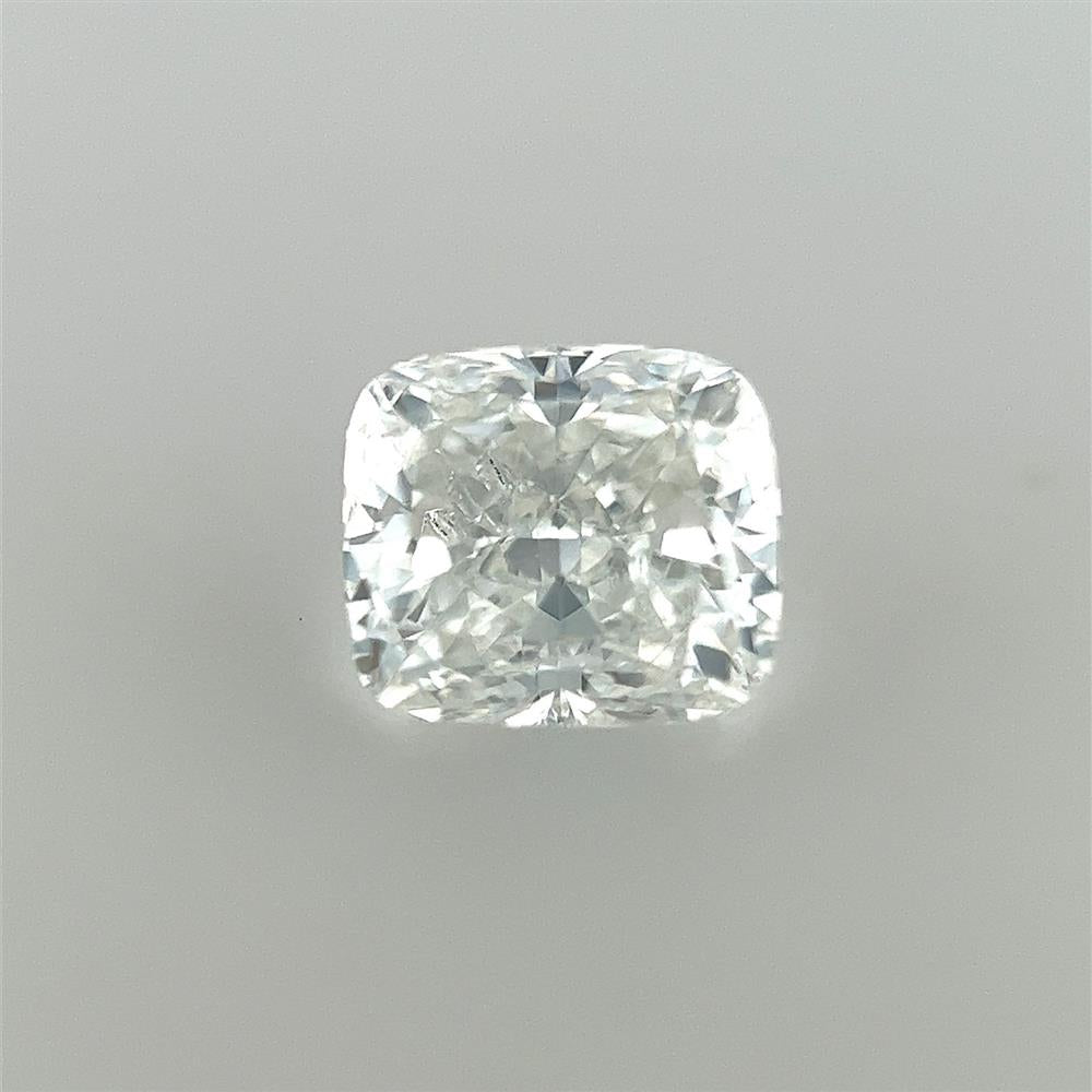 A Cedar Trading, Inc Cushion 0.90ct EGL Certified Natural Diamond with a clear, brilliant sparkle, shown against a plain, light grey background. The E Color diamond's facets are well-defined, capturing light and displaying a range of bright reflections. This SI1 clarity gem is perfect for those who appreciate timeless elegance.