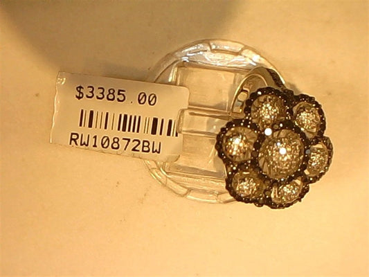 A Ryan Gems Black and White Diamond Flower Ring in 14k white gold, size 7, is displayed on a transparent stand with a $3385.00 price tag and code RW10872BW.