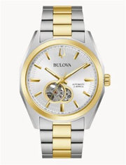 The Bulova Watch Company 98A284 Two Tone Surveyor Automatic Men's Watch features a silver and gold band, white dial with gold markers and hands, and an exposed mechanical movement in a circular window on the left.