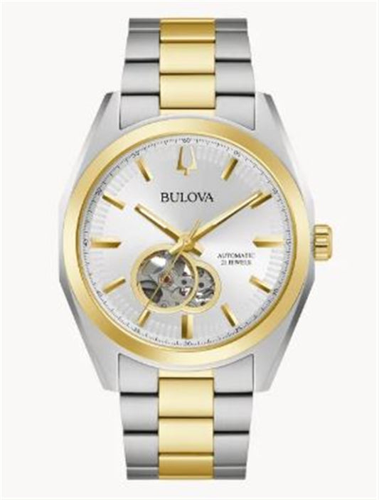 The Bulova Watch Company 98A284 Two Tone Surveyor Automatic Men's Watch features a silver and gold band, white dial with gold markers and hands, and an exposed mechanical movement in a circular window on the left.