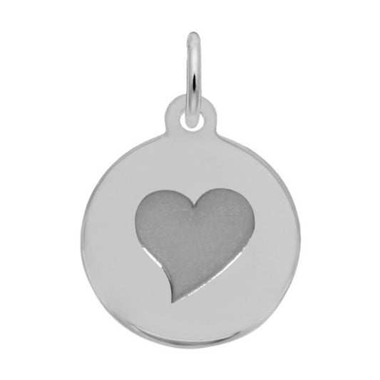 The Round Sterling Silver Pendant from Rembrandt Charms, named "Petite Disc - Heart Charm," features a cut-out heart in the center. It has a small loop at the top for easy attachment to a chain or bracelet. The design is simple and elegant, with a shiny, polished finish, ideal for those who appreciate timeless elegance.